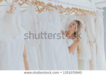 Сток-фото: Bride Choosing Dress In Bridal Boutique