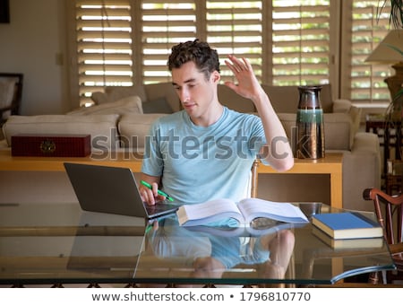 Zdjęcia stock: Young Handsome Male College Student Sitting In A Classroom