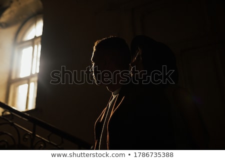 Stock foto: Young Wedding Couple Standing Against A Window