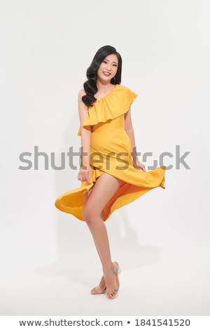 Stok fotoğraf: Portrait Of A Pretty Young Woman In Yellow Dress