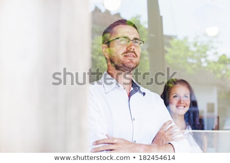 Stockfoto: Businesswoman At The Office Looks Through The Window For The Future Double Exposure