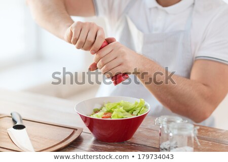 ストックフォト: Close Up Of Male Hands Seasoning Food By Salt Mill