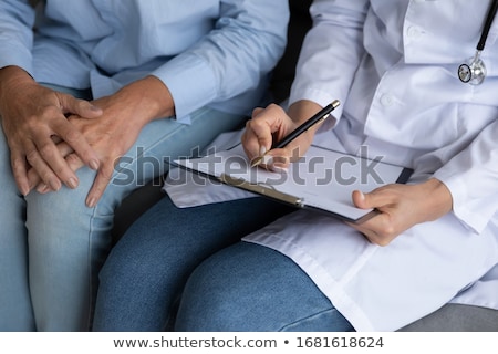 Foto stock: Doctor Or Nurse Explaining Prescription Medicine To Attentive Se