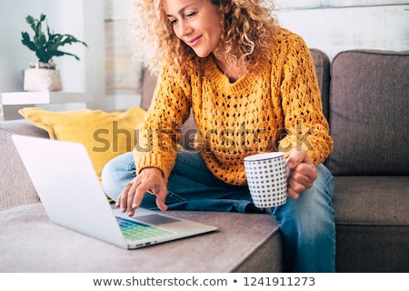 Stock photo: Smiling Woman At Laptop With Coffee