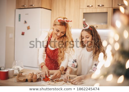 Stok fotoğraf: Young Woman Using Christmas Molds