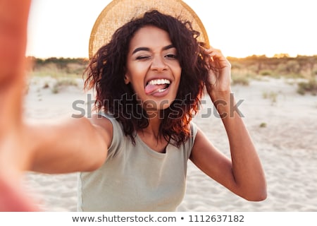 Foto stock: Young Woman Taking Selfie With Smartphone On Beach