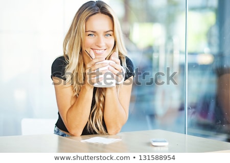 Foto stock: Happy Girl Drinking Coffee In Kitchen