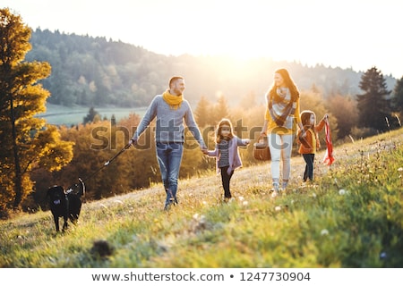 Zdjęcia stock: Woman And Man Petting The Dog Walking It In A Colorful Fall Setting