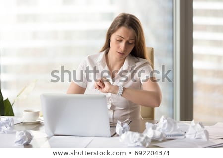 Foto stock: Woman Checking Time While Sitting In A Meeting