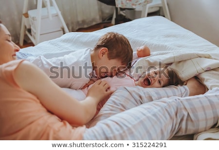 [[stock_photo]]: Family In Bed Together On Sunday Morning