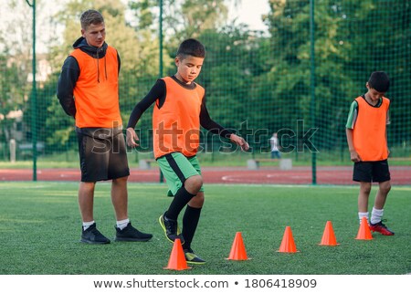 Stock fotó: Orange Soccer Ball On Plastic Grass