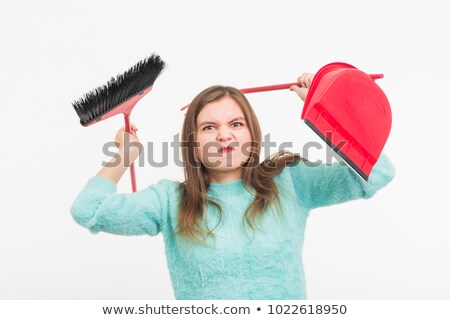 Foto d'archivio: Tired Young Woman Holding Broom