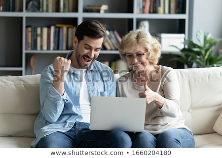 [[stock_photo]]: Adult Son And Senior Mother Using Laptop At Home