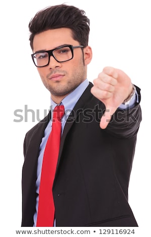 Foto stock: Serious Young Fashion Man Showing The Thumb Down Gesture
