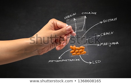Stock photo: Handing Over Pills With Blackboard Wallpaper