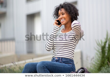 Stockfoto: Cheerful Woman Outdoors Talking By Mobile Phone