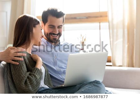 Stock photo: Affectionate Couple Enjoy Spending Weekends Together Watch Interesting Film On Laptop Computer In B