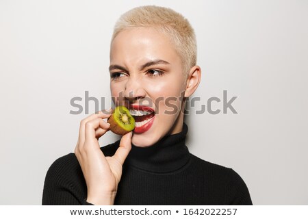 ストックフォト: Blonde Stylish Woman Holding Kiwi