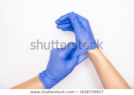 Zdjęcia stock: Stretching A Blue Latex Glove