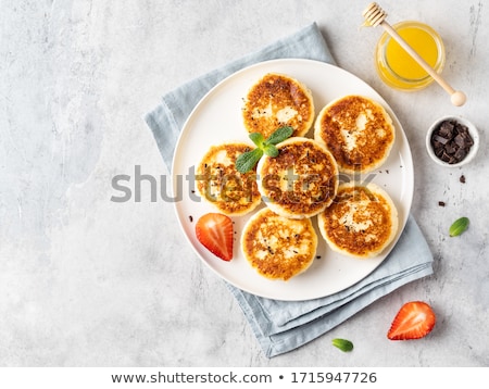 Stock photo: Delicious Cottage Cheese Pancakes Or Syrniki With Fresh Blueberry In Cast Iron Pan On Dark Wooden Ru