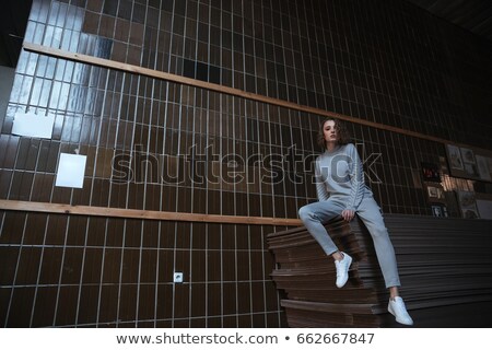 Сток-фото: Girl Sitting In Gallery And Looking Aside