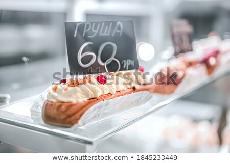 Foto stock: Close Up Of White Eclair With Nuts