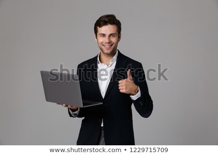 Stock fotó: Image Of Happy Businessman 30s In Suit Rejoicing While Using Lap