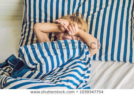 ストックフォト: The Cute Boy Woke Up In His Bed Children Sleep Concept