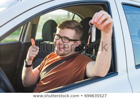 Stock photo: Man Holding Key In Front Of Road