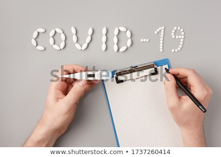 Stock photo: The Inscription Covid 19 Of Tablets Tablets And A Thermometer