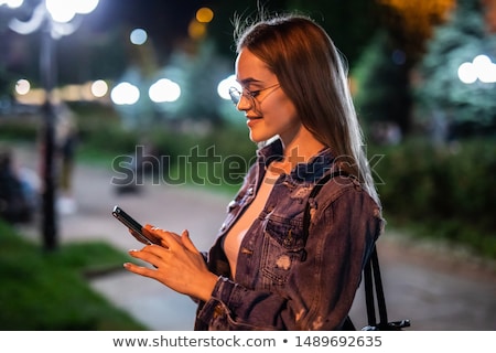 Stock photo: Woman Using Smartphone On Street At Night