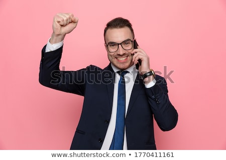 Foto stock: Enthusiastic Businessman Talking On The Phone Celebrates And Loo