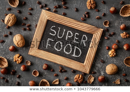 Foto stock: Inscription Super Food Various Nuts On Stone Table