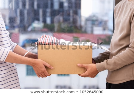 Stock photo: Man Donating Clothes In Donation Box