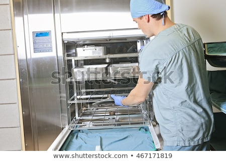 Foto stock: Men Working On A Sterilizing Place In The Hospital