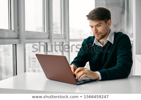 Foto stock: Portrait Of A Young Guy Using Laptop At Home