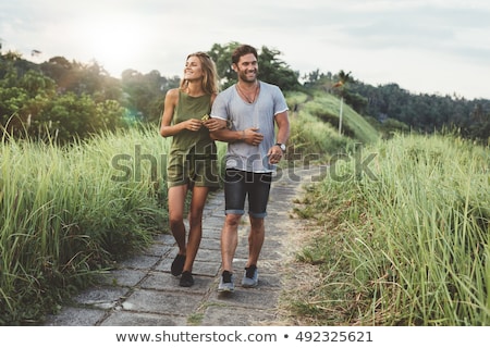 Foto stock: Young Couple Walks In Park