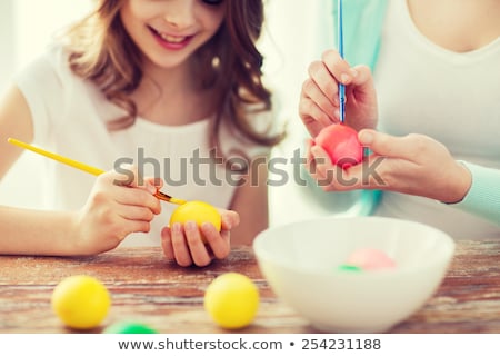 Foto d'archivio: Person Painting Easter Egg With Brush