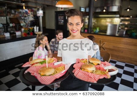 [[stock_photo]]: Portrait Of Smiling Waitress Holding Food Tray