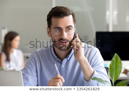 Foto stock: Businessman Calling On Smartphone At Office