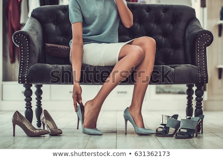 Foto d'archivio: Happy Young Woman Choosing Shoes At Store