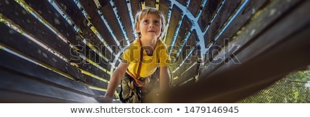Stockfoto: Little Boy In A Rope Park Active Physical Recreation Of The Child In The Fresh Air In The Park Tra