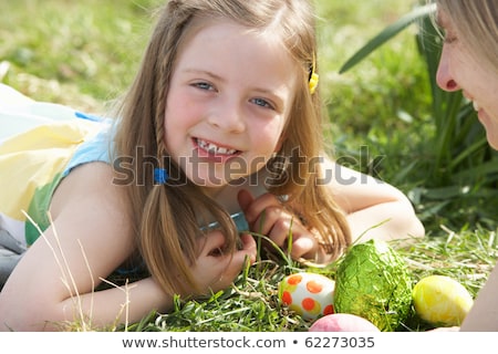 ストックフォト: Mother And Daughter On Easter Egg Hunt In Daffodil Field