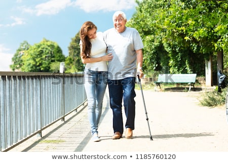 [[stock_photo]]: Woman Assisting Her Father While Walking