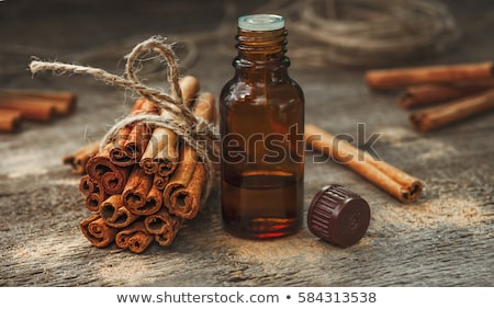 Stock photo: A Bottle Of Cinnamon Essential Oil With Cinnamon Sticks