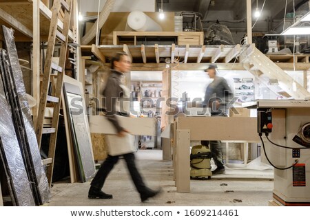 Foto stock: Two Young Men Working In The Furniture Factory