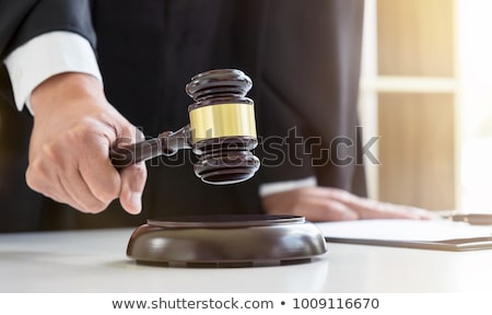 Foto stock: Close Up Of Male Lawyer Or Judge Hands Striking The Gavel On So