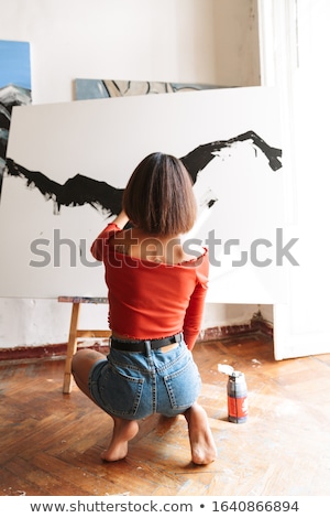 Stock photo: Portrait Of Young Woman Using Painting Tools While Drawing In St