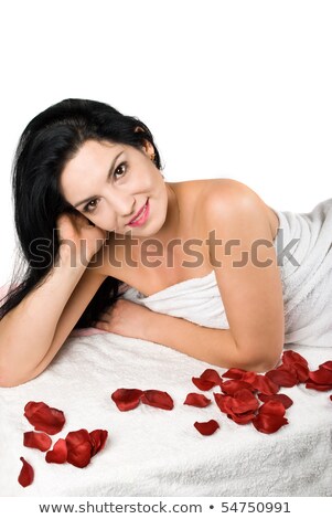 Imagine de stoc: Closeup Portrait Of A Lady Laying On Rose Petals