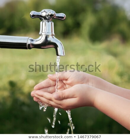 Stockfoto: Boy And Girl Holding Hands Under Tap